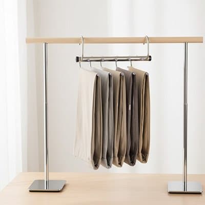 Cintre pantalon​ suspendu sur portant vêtement
